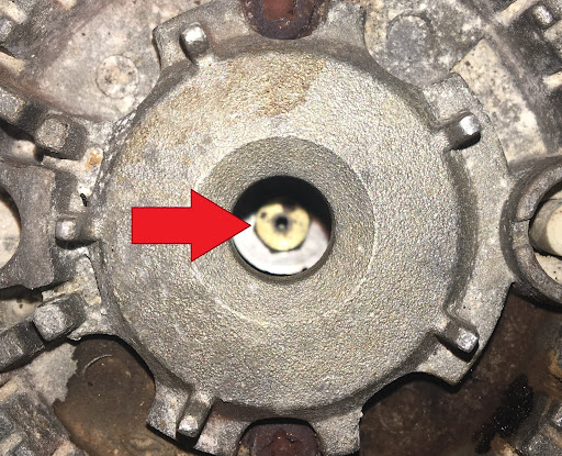 The small brass orifice in the center of the burner is what needs to be cleaned.jpg